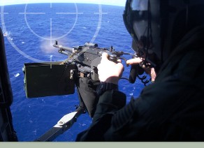 United States Marines firing M240D with spade grip from helicopters during training excercises for Operation Iraqi Freedom. M-240D medium action machine guns can be stored in Combat Weapons Racks with the bi-pod attached to the weapon.