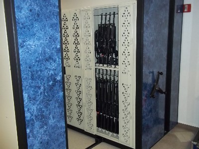 Weapon Racks on mobile carriages for military arms rooms requiring high density weapon storage.